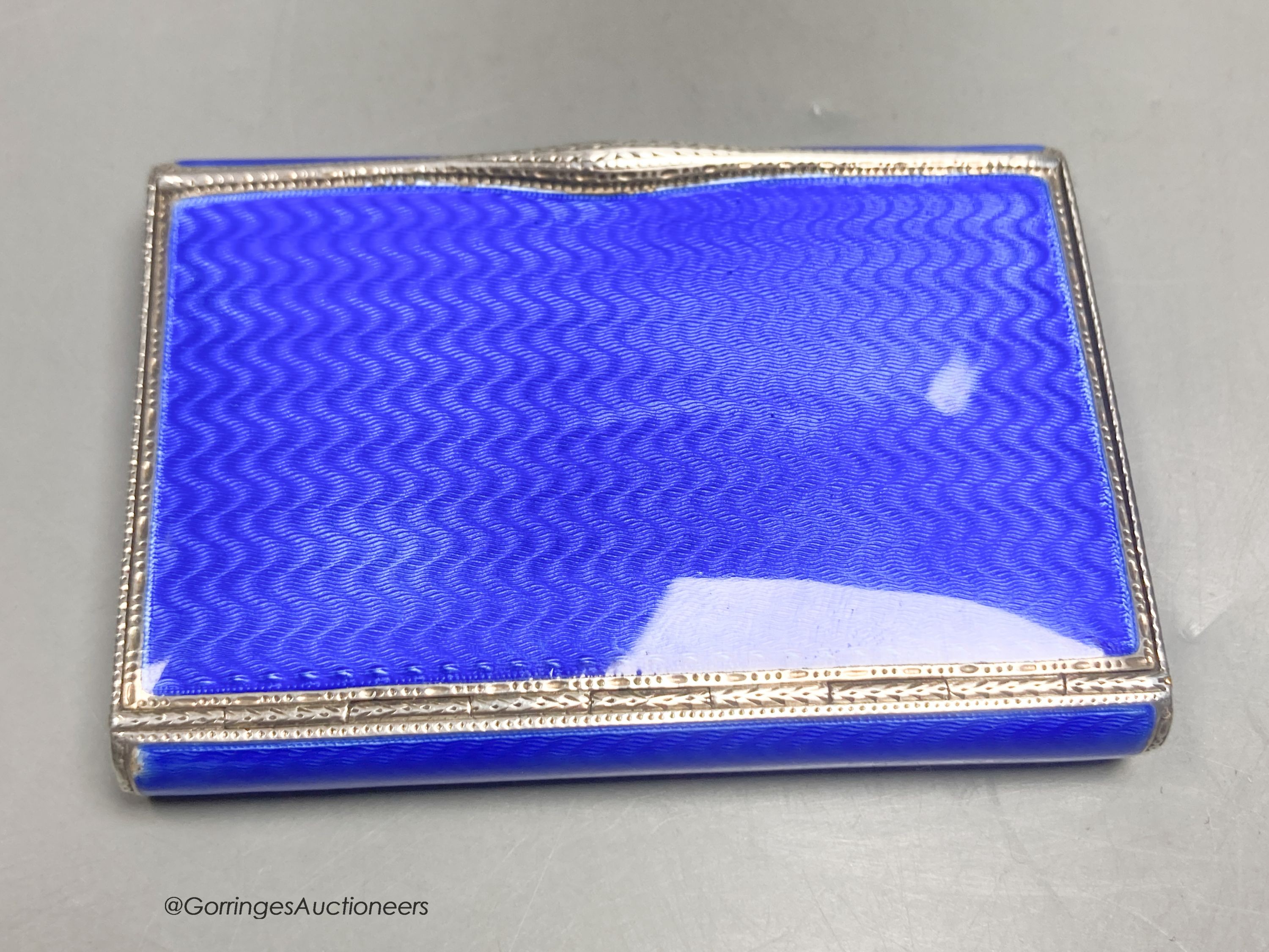 A 1920's continental silver and blue guilloche enamel rectangular box with hinged cover, import marks for DC, London, 1927, 77mm by 55mm by 12mm